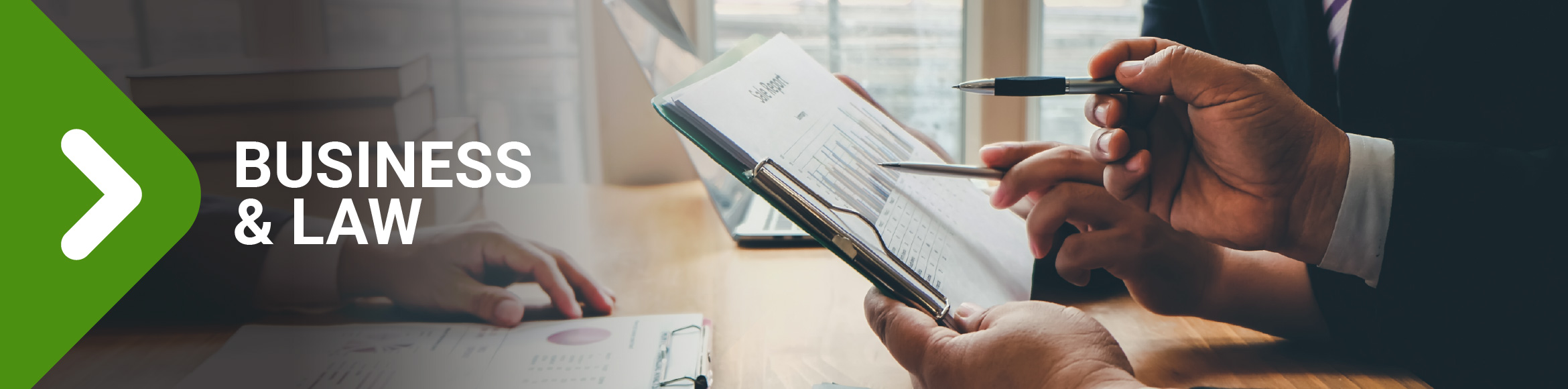 "Business & Law" arrow graphic over photo of people reviewing papers at a desk